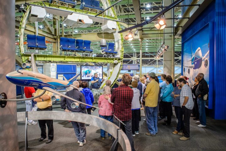 a group of people listening to a tour guide