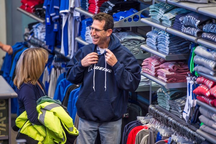 a happy person trying on a sweatshirt