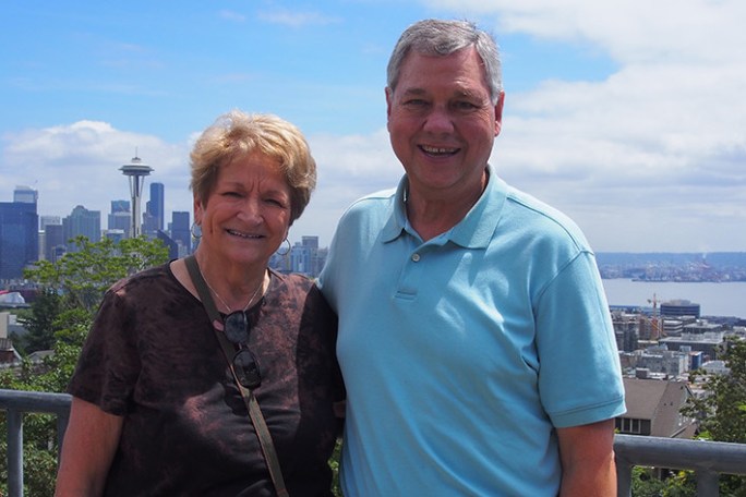 couple standing in front of Seattle Skyline
