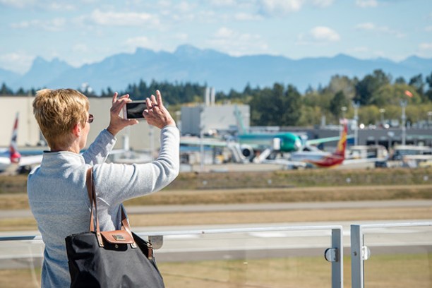 a person taking a photo of a runway and planes