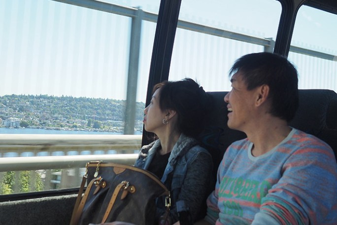 a man and a woman sitting on the Seattle City Tour Bus