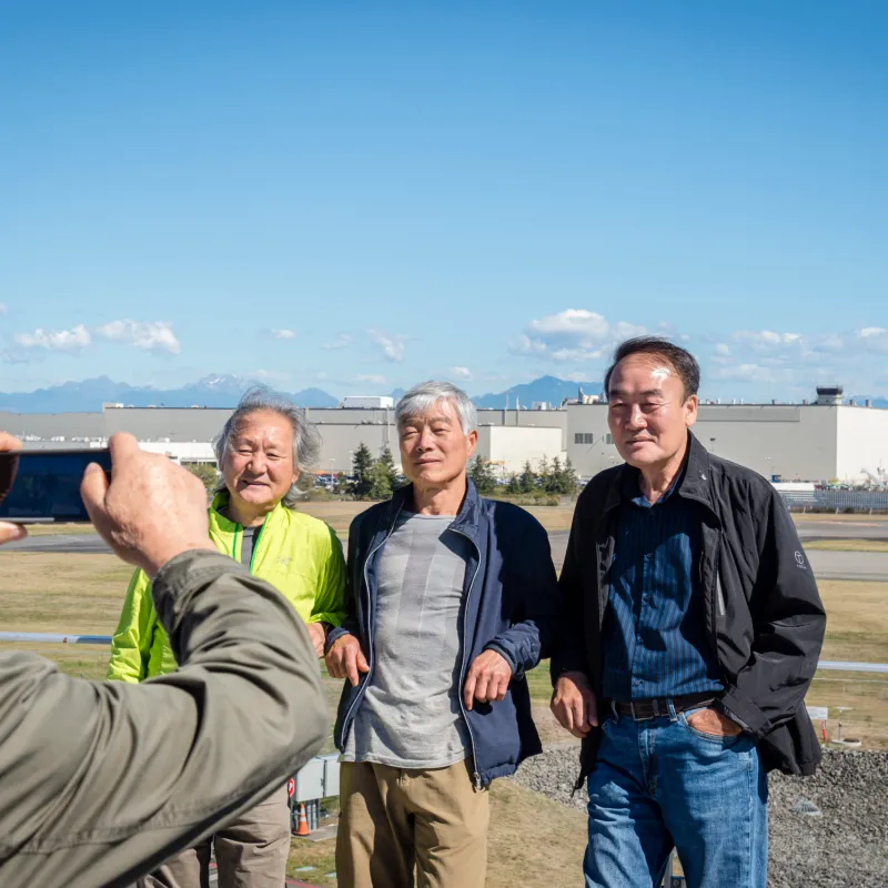 people getting their photo taken in front of boeing factory during a Tours Northwest guided tour