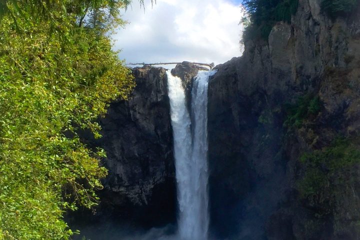 a large waterfall in a forest seen on a Snoqualmie Falls Tour from Seattle