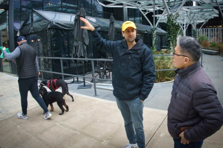 a group of people walking on a sidewalk