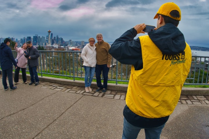 a group of people standing on a sidewalk