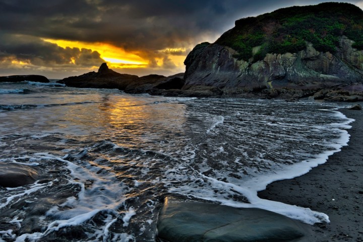 a large waterfall over a body of water