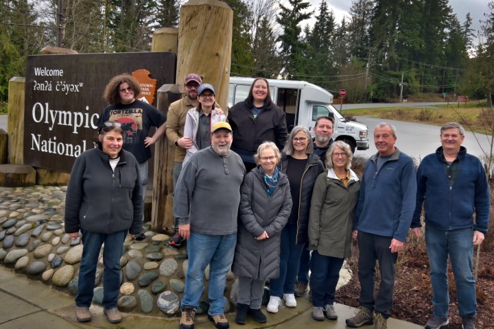 a group of people standing in front of a crowd posing for the camera