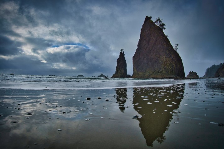 a group of people standing next to a body of water