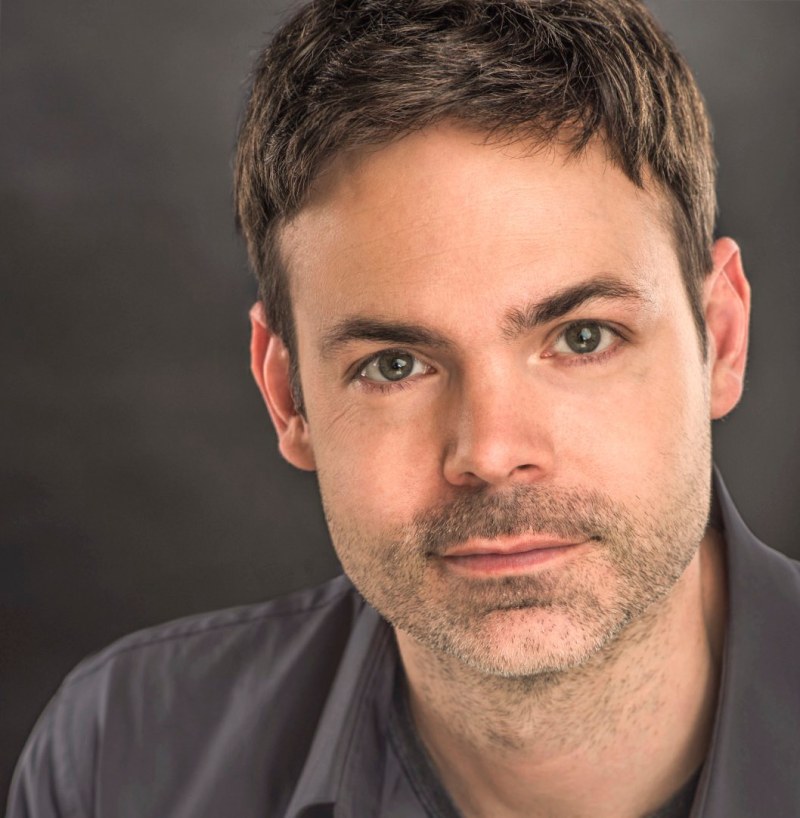 a tours northwest tour guide with brown hair posing for the camera