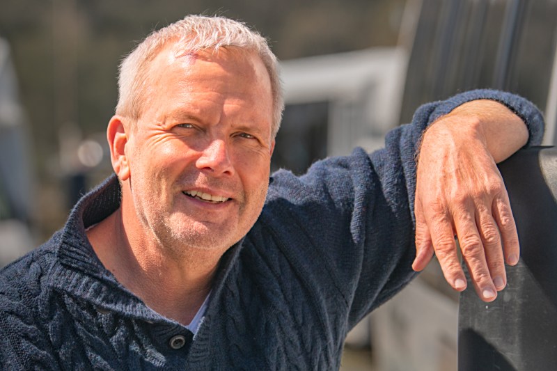 a tours northwest tour guide with a sweater on posing for the camera