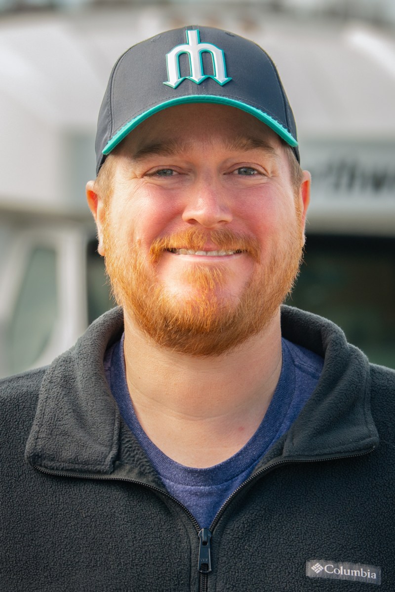 a tours northwest tour guide wearing a hat