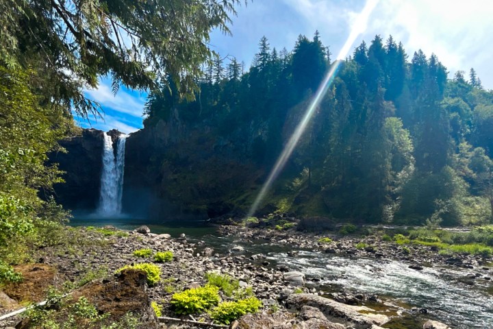a large waterfall over a body of water