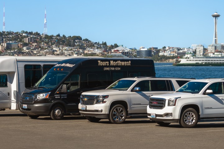 Tours Northwest private suv tours and city tour bus in front of the seattle skyline