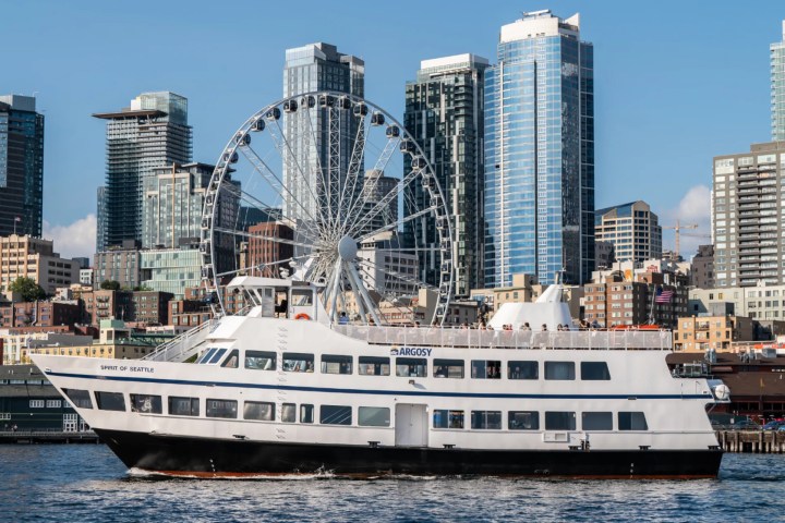 the Argosy Harbor Cruise ship in front of the ferris wheel in Seattle seen on the Ultimate Seattle Experience tour with Tours Northwest