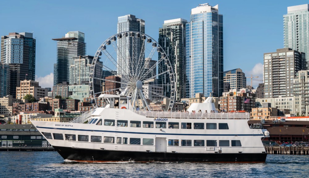 the Argosy Harbor Cruise ship in front of the ferris wheel in Seattle seen on the Ultimate Seattle Experience tour with Tours Northwest