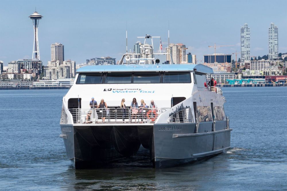 Ferry on water with Seattle skyline and Space Needle in the background.